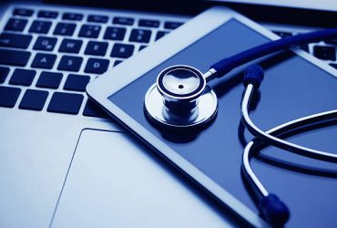Stethescope on the tablet with keyboard of laptop